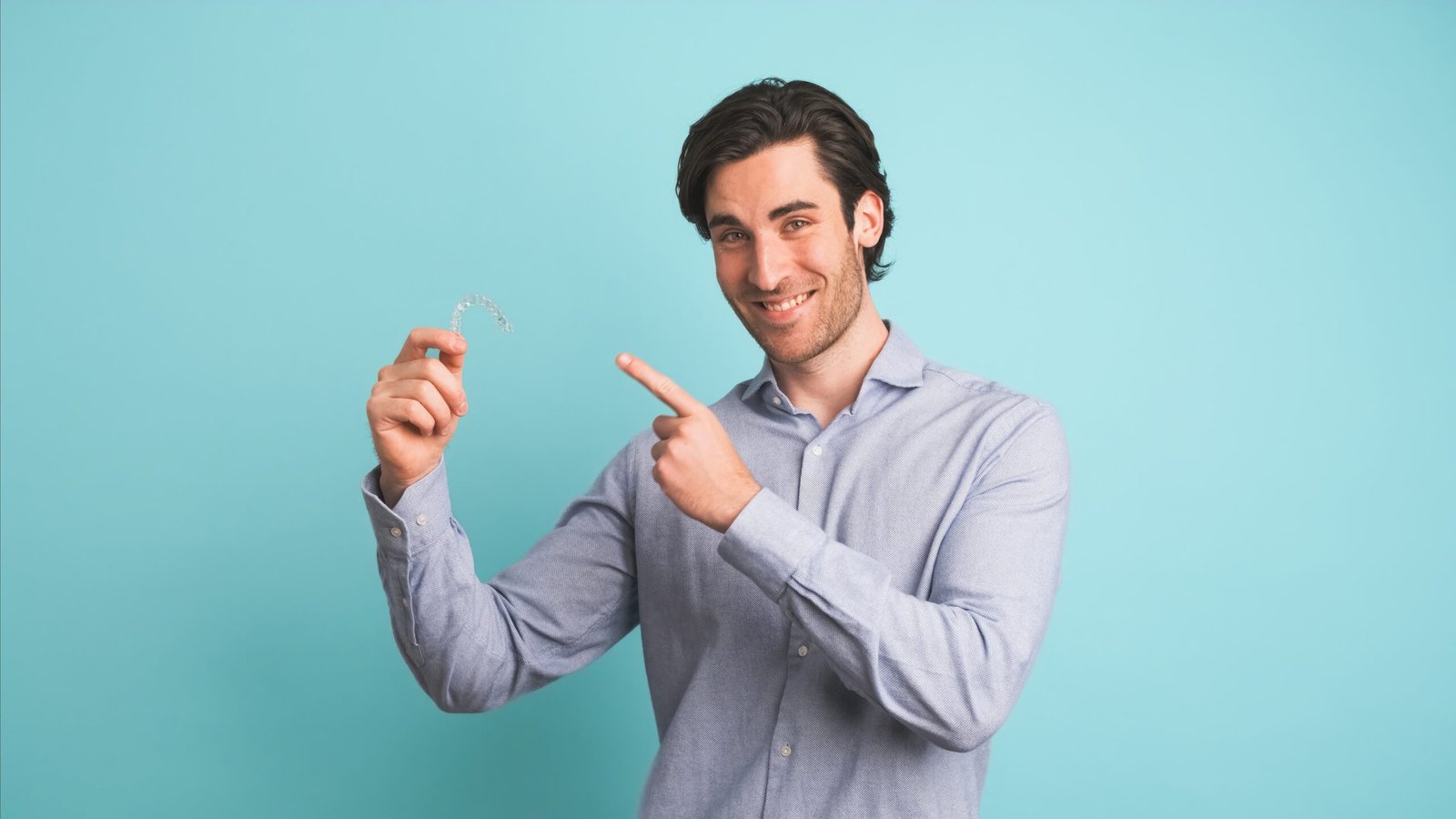 What Makes Invisalign a Popular Choice? 1 Happy man showing