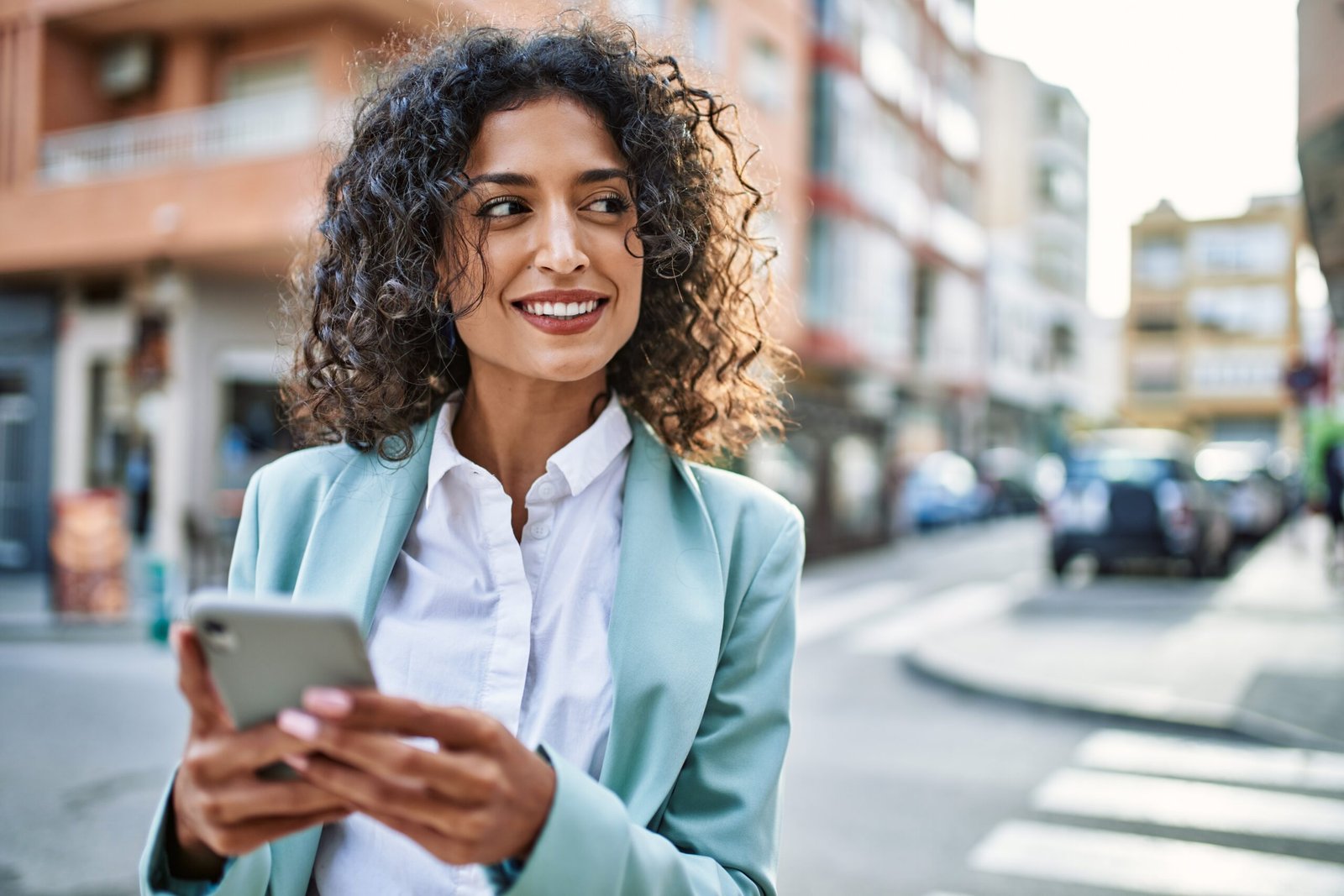 How Invisalign Quietly Builds Confidence in Your Everyday Life 5 Young hispanic business woman wearing professional look smiling confident at the city using smartphone